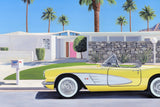 Yellow vintage car parked in front of a modern house with palm trees.