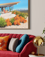 Sophisticated mid-century modern living room boasting artwork of the iconic Stahl House and a woman lounging poolside in a chic floppy hat and bikini, taking in the breathtaking Los Angeles skyline view