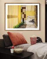 A gorgeous artwork featuring a classic car and a mid-century home in Palm Springs on display in the lounge room