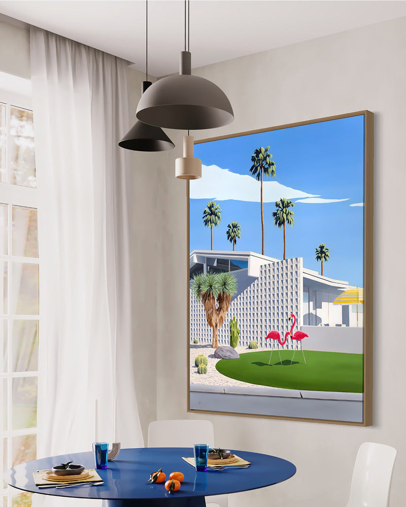 Step into a stylish mid-century room featuring artwork capturing two pink flamingos, palm trees, cactus gardens, and an architecturally designed mid-century modern home
