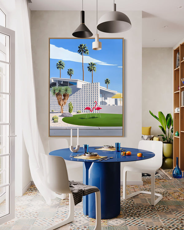 A stylish mid-century room with artwork showcasing two pink flamingos, palm trees, cactus gardens, and an architecturally designed modern home