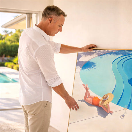 Jarrod Riggs setting up a poolside scene with a decorative pool cover featuring a woman by a pool.