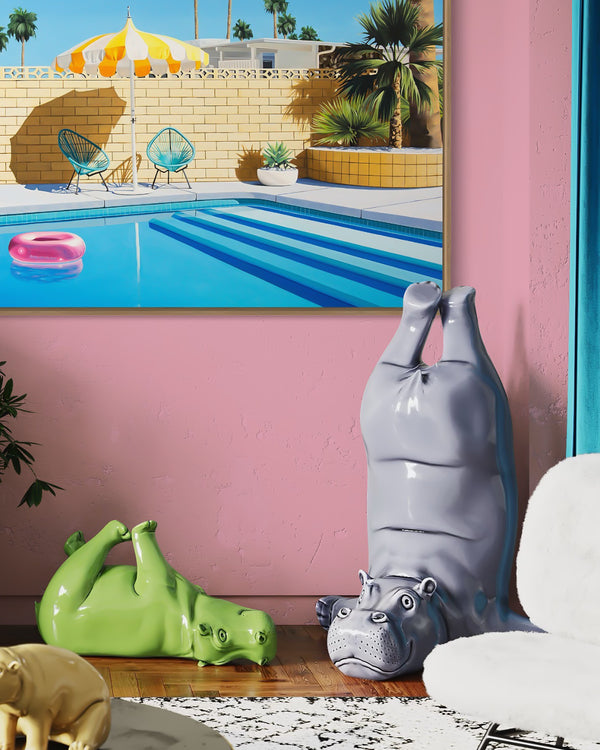 A beautiful space adorned with an artwork showcasing a summery pool scene with a pink inflatable pool ring and a yellow and white striped umbrella in Palm Springs