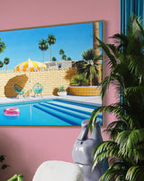 A luxurious space with a striking pool scene artwork, featuring a yellow and white striped umbrella and a pink inflatable pool ring on a sparkling swimming pool in the beautiful Palm Springs sunshine
