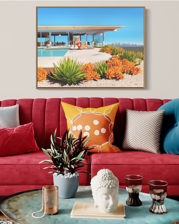 "Mid-century modern living room with Stahl House artwork and Los Angeles skyline view, featuring a woman in a wide-brimmed floppy hat lounging poolside in a bikini