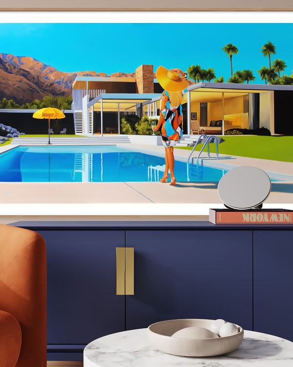 Stylish mid-century room with Kaufmann house artwork and a brand new take on Slim Aarons Poolside Gossip. Woman in a floppy hat lounges poolside on a sunny day.