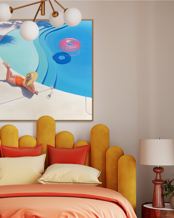 A glamorous bedroom with an exquisite artwork of a woman sipping a cocktail and relaxing by a stunning swimming pool