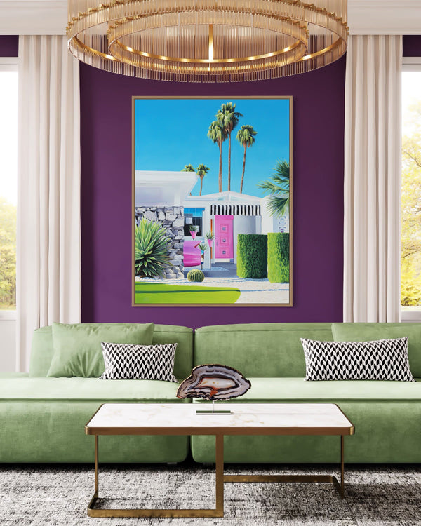 Midcentury modern artwork in a stylish living room. A pink Cadillac sits in the driveway while palm trees sway in the background
