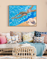 A piece of art in a contemporary living room depicting a young girl in a vibrant bikini, enjoying a serene swim in a beautiful pool