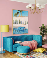 This beautiful artwork captures the essence of Palm Springs with its colorful pool floats and serene desert oasis pool